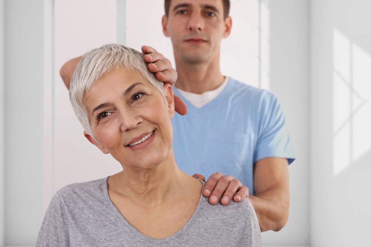 Woman having chiropractic back adjustment. Osteopathy, Physiotherapy, Injury rehabilitation concept