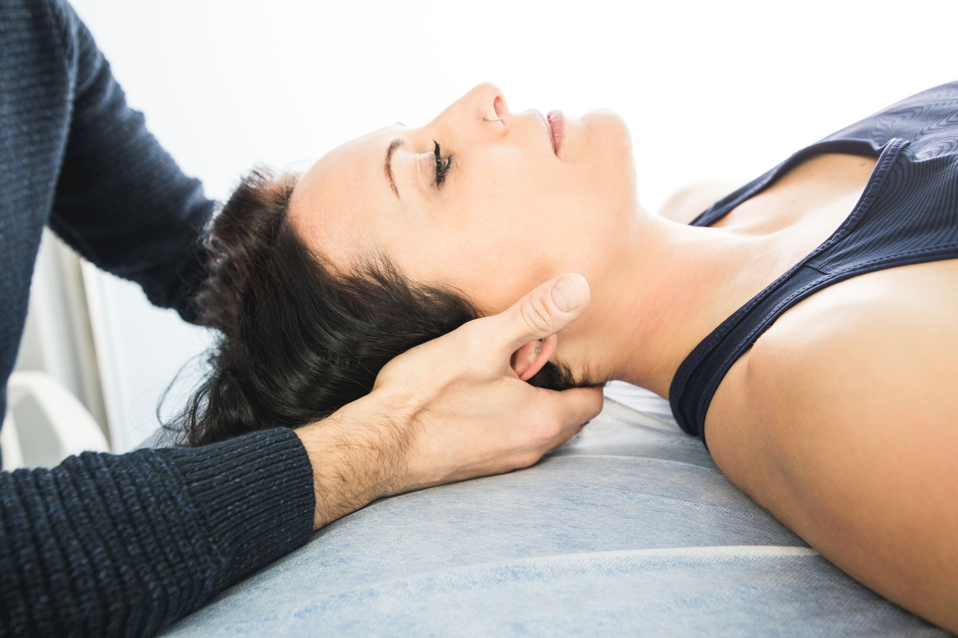 Physiotherapist working on massaging a patient in the neck. Concept of physiotherapy and rehabilitation