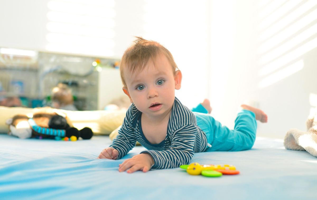 beautiful blue eyed baby kid crawling in bed